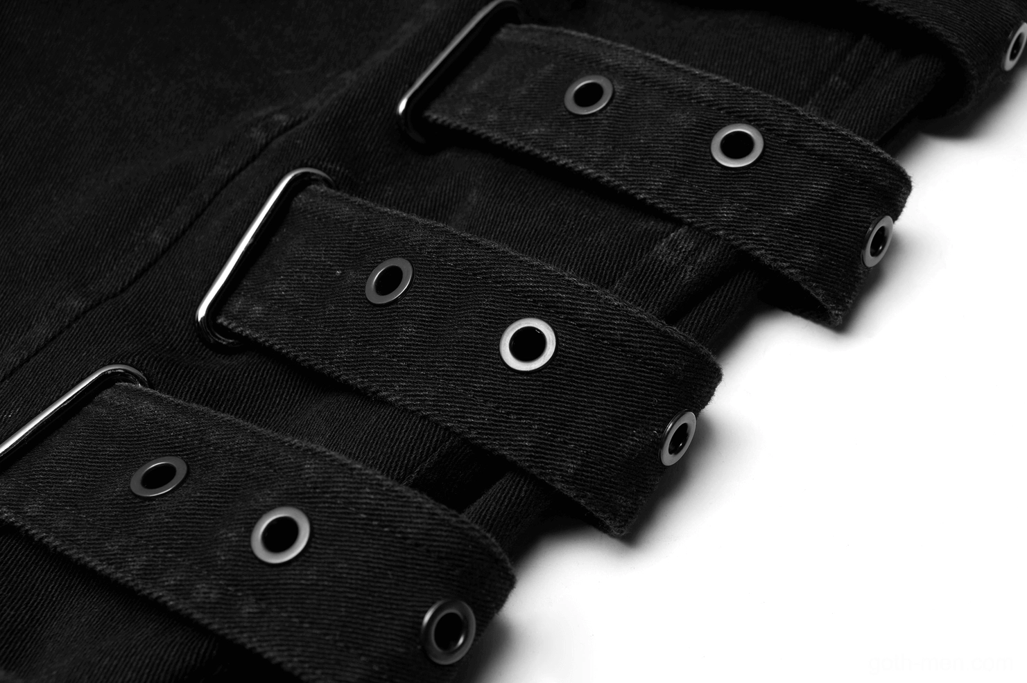 Detailed macro view of metal eyelet strap buckles and black textile construction