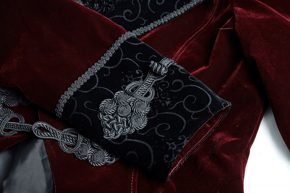Close-up side view of wine red tailcoat cuff with embroidered braided trim and decorative frog closure