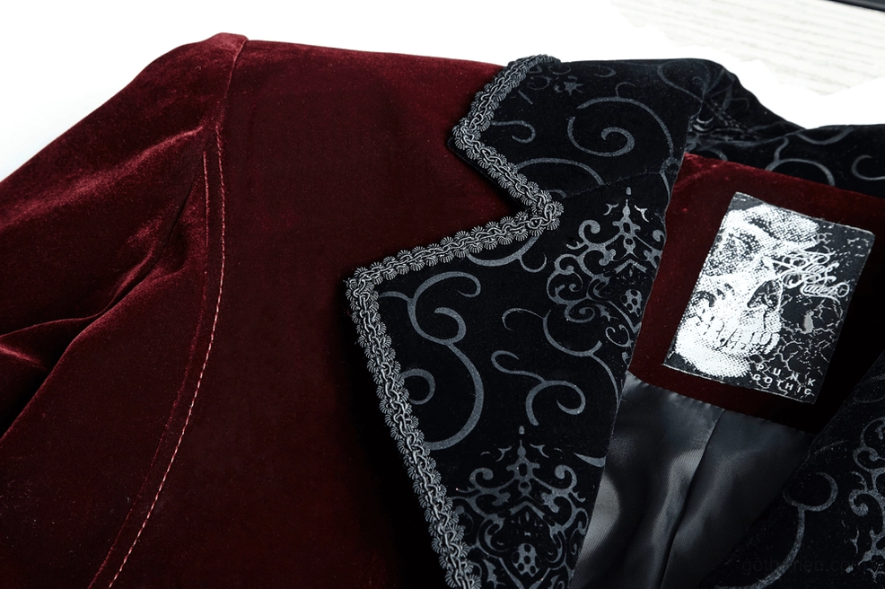 Close-up detail of embroidered black lapel on wine red tailcoat jacket with printed inner label