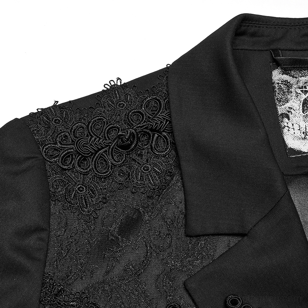 Macro detail shot of gothic tailcoat shoulder and peaked lapel featuring skull brand label and jacquard embroidery craftsmanship