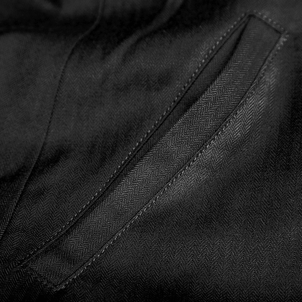 Precision topstitching and herringbone woven fabric detail of black gothic tailcoat seams