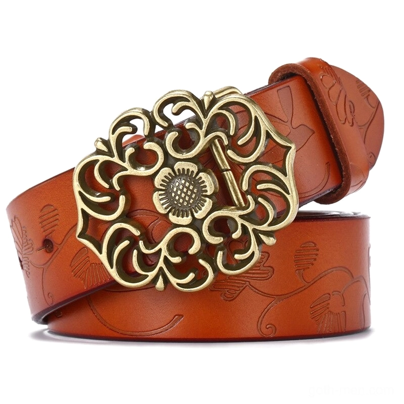 Tan brown leather gothic belt with embossed plant patterns and polished bronze vintage pin buckle, flat lay