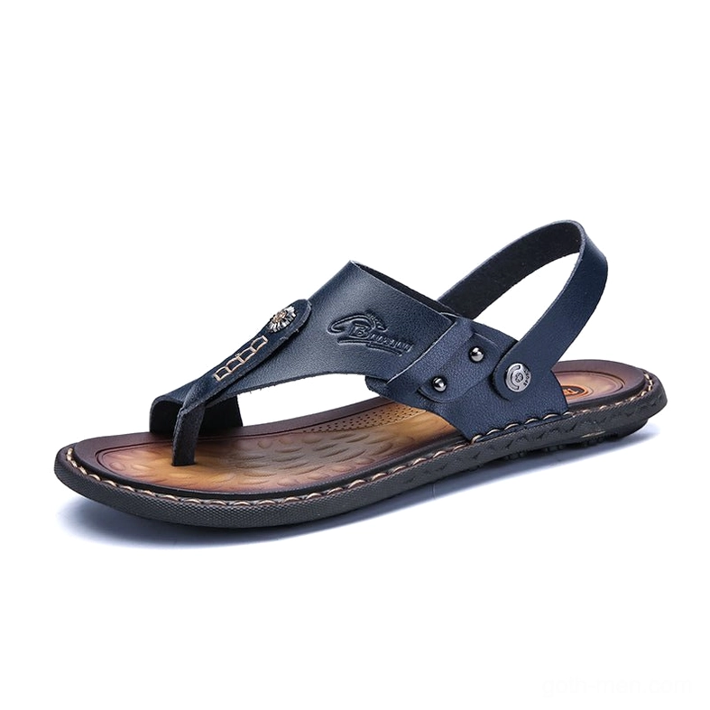 Tan leather microfiber sandals with metal rivets and brown outsole - front three-quarter view