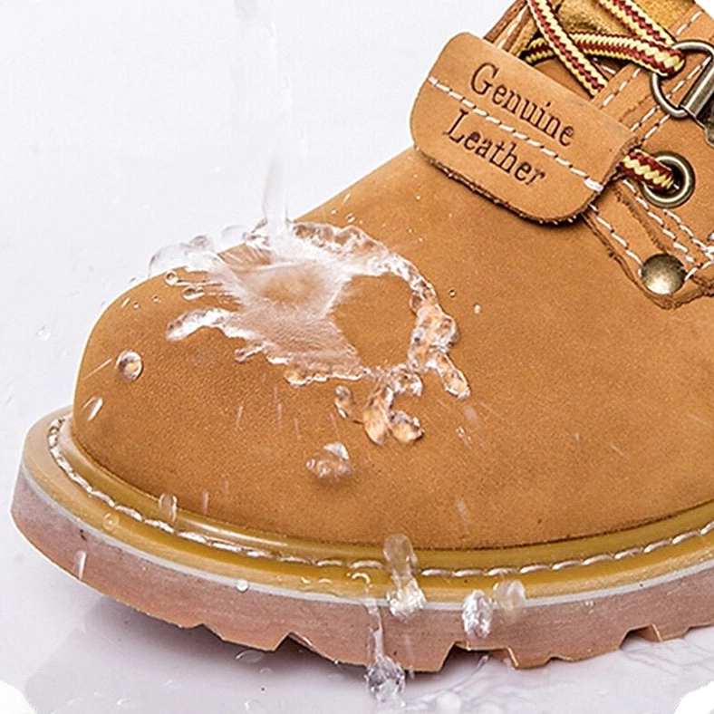 Genuine leather work boots in tan showing water-resistant qualities - close-up front view with leather authenticity label visible