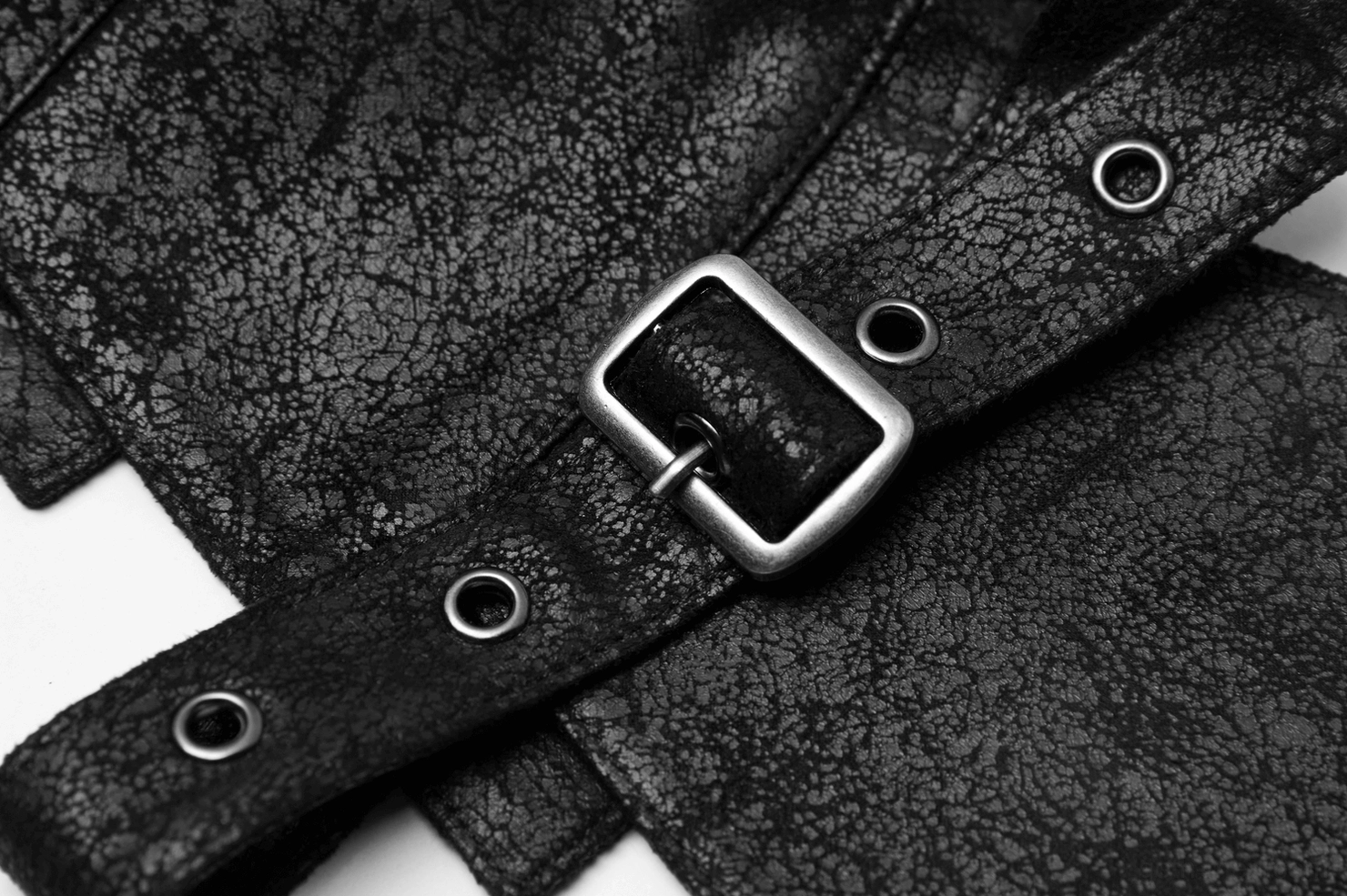 Square metal grommet buckle and reinforced holes on gothic leather vest adjustable strap