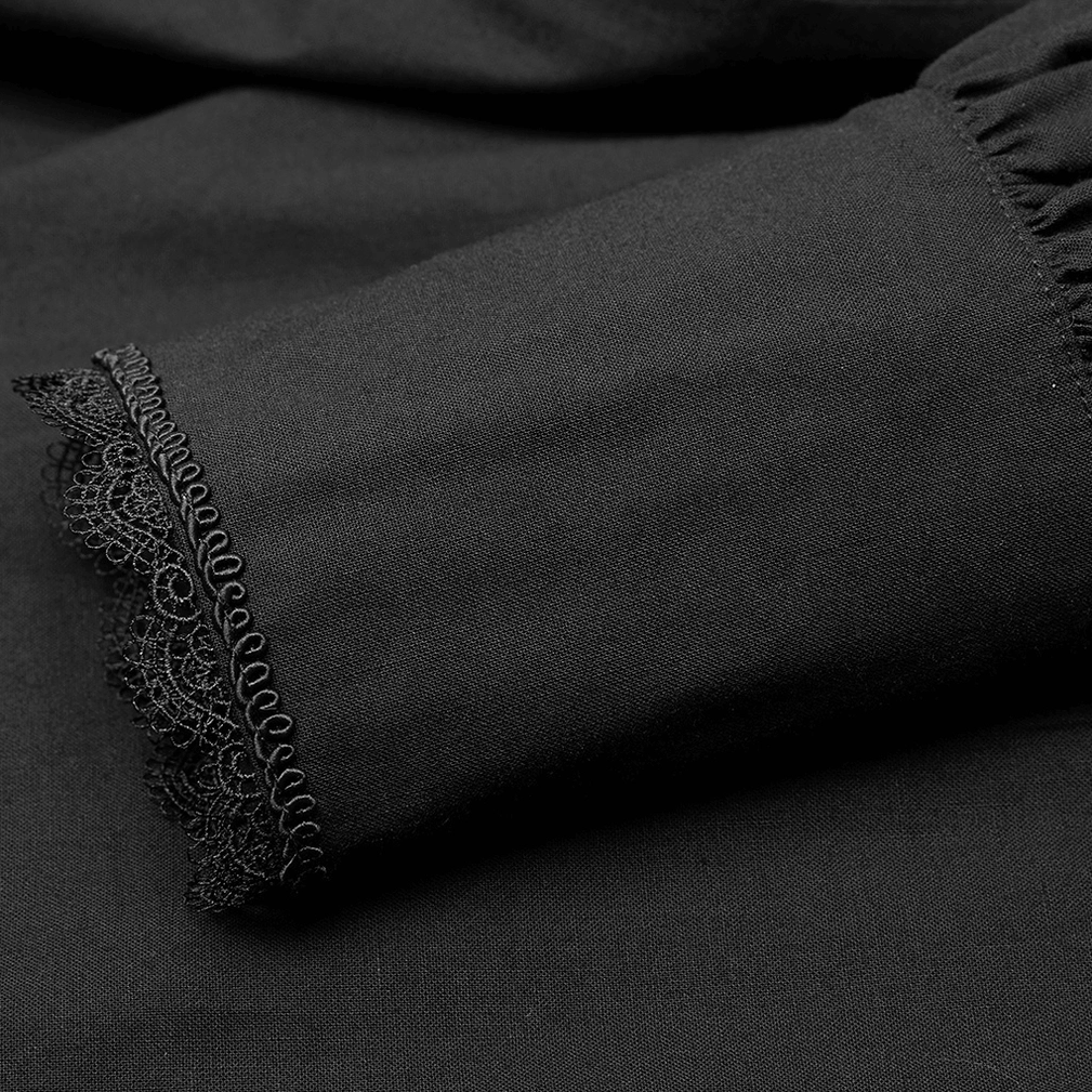 Close-up of gothic ruffled shirt cuff trim showing embroidered lace border on cotton