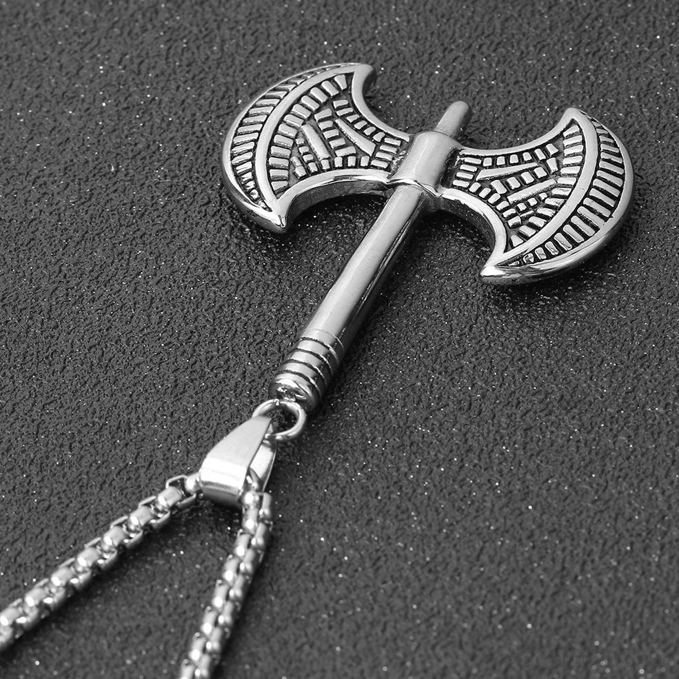 Viking axe pendant with chain oblique side view engraved patterns dark background