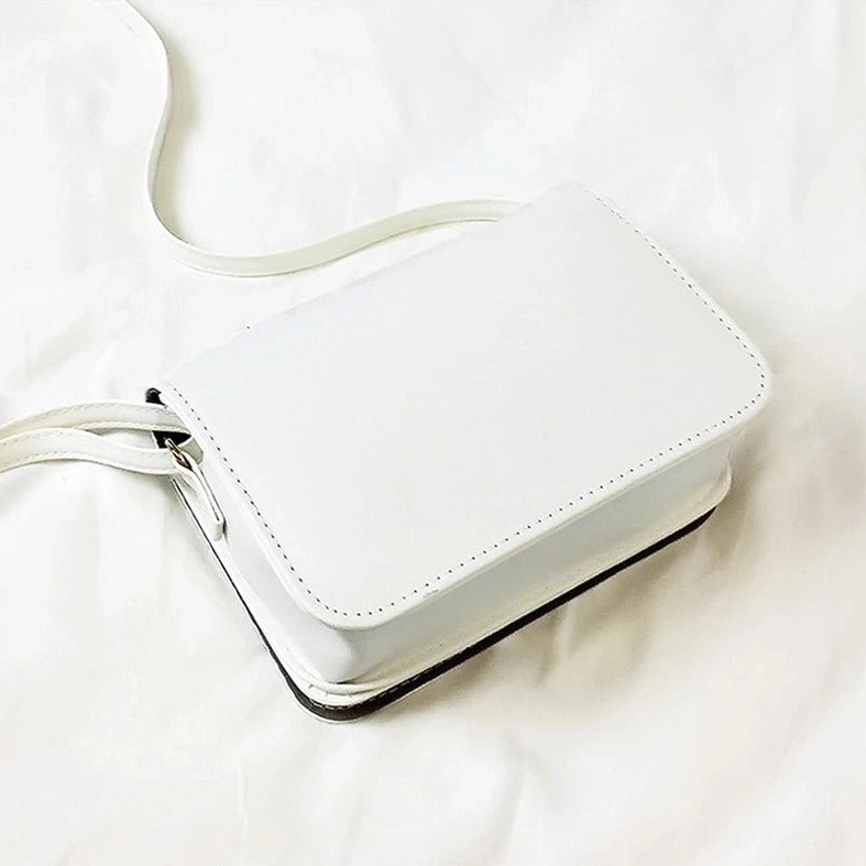 White faux leather gothic letter bag with smooth stitched edges and structured book-style design