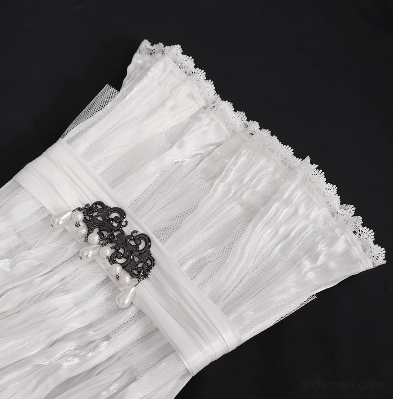 Flat lay overhead view of white pleated mesh gothic collar with lace edge and ornate black metal beaded brooch on black background