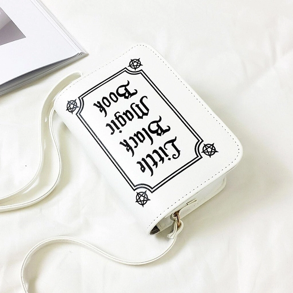 White gothic letter bag flat lay back view showing reversed text print and adjustable shoulder strap
