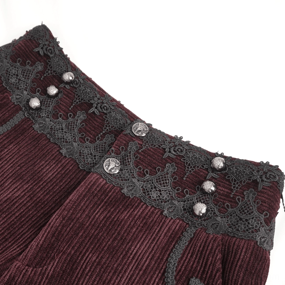 Front waist detail of wine red corduroy gothic trousers displaying lace trim craftsmanship and button closure
