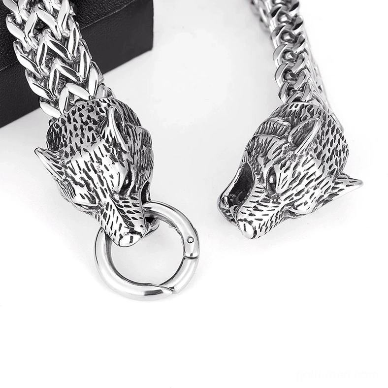 Macro close-up of exquisite wolf head carving on stainless steel gothic bracelet, exposed chain links and spring ring clasp